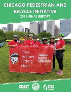 2019 Bike Ambassadors holding sign advertising free helmet fittings.